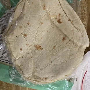 a tortilla wrapped in plastic wrap