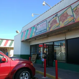 a red truck parked in front of a restaurant
