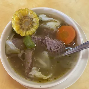 a bowl of soup with meat and vegetables
