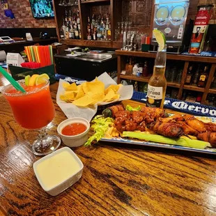 a platter of chicken wings and chips