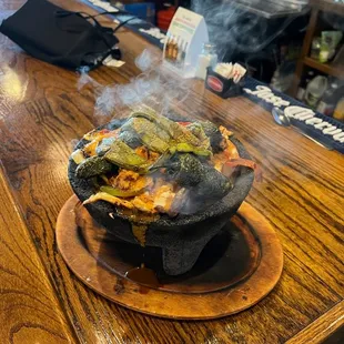 a hot pot of food on a bar
