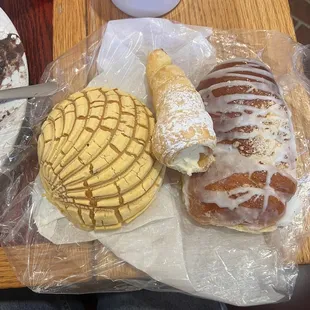 Pan dulce, shoehorn filled with cream, and one that tastes like a danish (recommended by the worker)