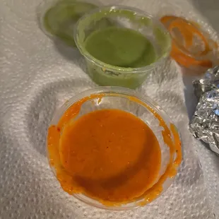 The orange sauce is spicy!! but so good. The green sauce is milder but still on the spicy side