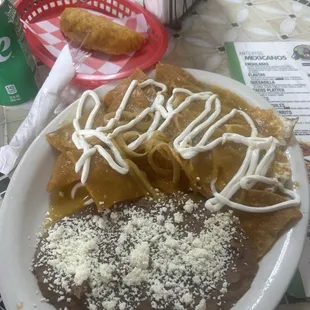 Chilaquiles and empanada photo bomb in the upper right