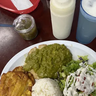 Grilled tilapia topped with their La Olla sauce, fried plantains, rice and salad with ranch dressing