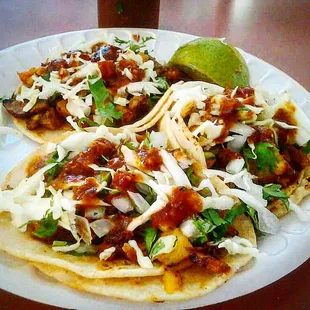 Al Pastor tacos with marinated pork, onions, pineapple, &amp; cilantro.