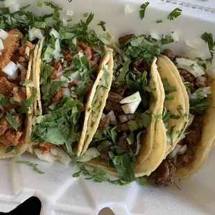 three tacos in a styrofoam container
