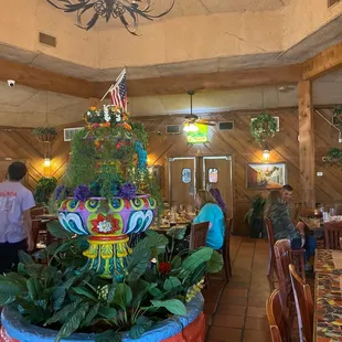 a colorful christmas tree in a restaurant