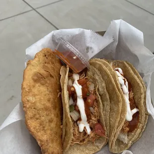 2 chicken tacos and a beef empanada