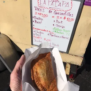 a hand holding a piece of food