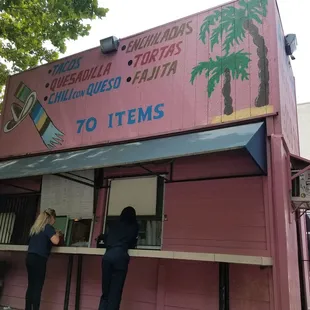 Pink taco hut outside. Popular lunch spot