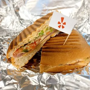 a cut in half sandwich on tin foil