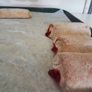 four pastries on a baking sheet