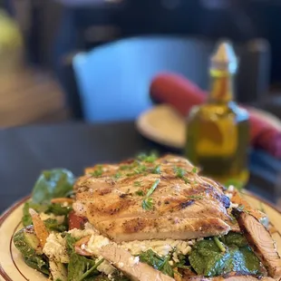 a plate of chicken and spinach salad
