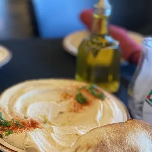 a plate of pita bread and a bottle of olive oil