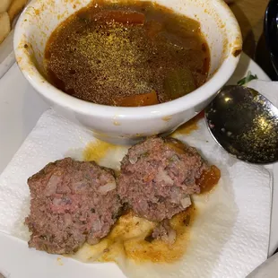 a bowl of soup and meatballs