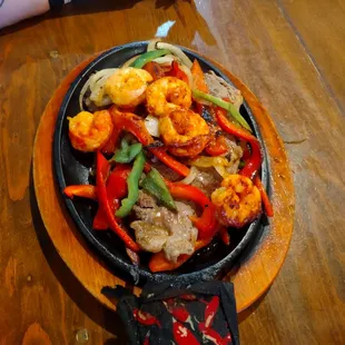 Carne asada plate with shrimp grilled peppers and onion