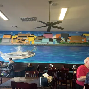 a mural of a boat on the water