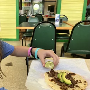 beef fajita taco with avocado.  Comes with lime and hot sauce.