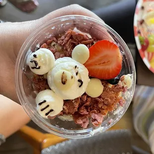a person holding a bowl of food