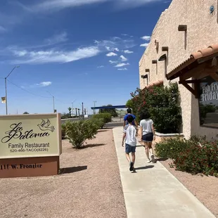 two people walking down the sidewalk