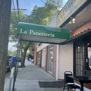 a woman standing in front of a restaurant