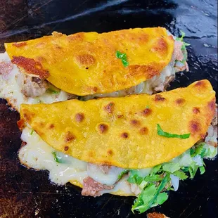 two quesadillas with cheese and lettuce
