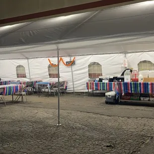 tables and chairs under a tent