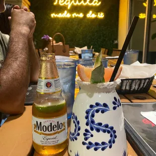 a man sitting at a table with a drink