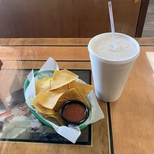 a drink and chips on a table