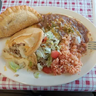 Combo #3. The special for today. Enchilada, Gordita, empanada, beans and rice with green chili.  Served VERY quickly. All tasty so far.