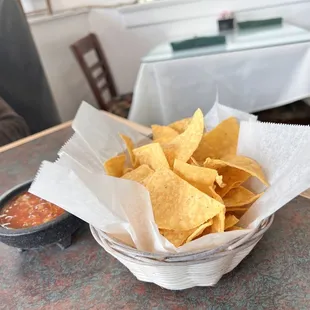 a basket of chips and salsa