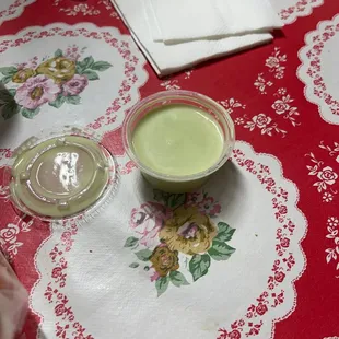 a glass of green liquid on a table