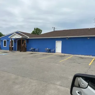 a blue building in a parking lot