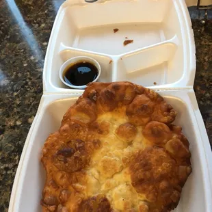 a pizza in a styrofoam container