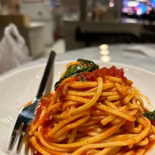 a plate of spaghetti with tomato sauce