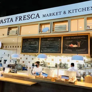 two people working behind the counter