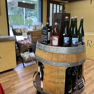 a display of wine bottles in a barrel