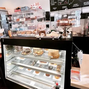 a bakery counter with a variety of pastries