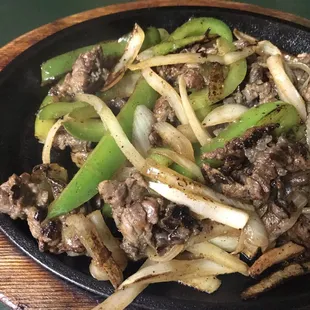 a skillet of beef and onions