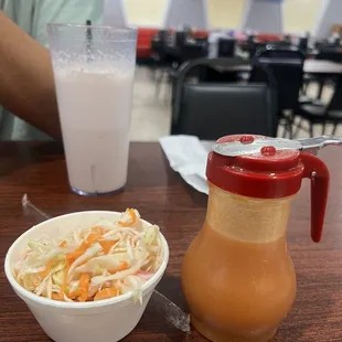 Curtido and salsa, the drink in the back is a liquado de fresa y banana