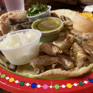 Delicious tacos served on a paper plate.