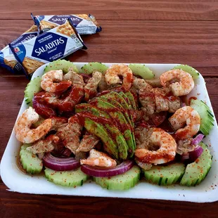 a plate of shrimp and cucumber salad