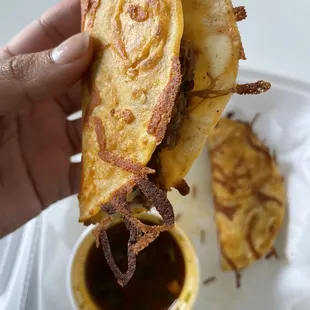 a hand holding a piece of food