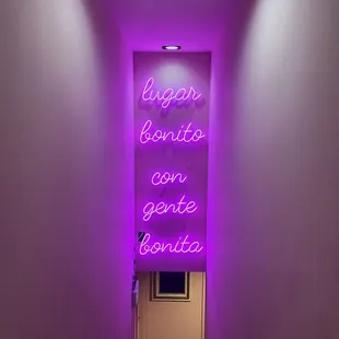 a neon sign in a hallway