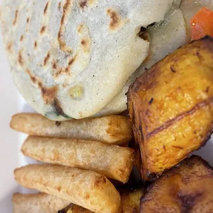 Two pupusa with fried platanos and yuca to go