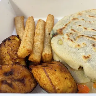 Two pupusa with fried platanos and yuca