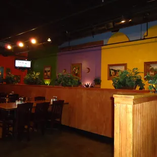 a brightly colored restaurant with tables and chairs