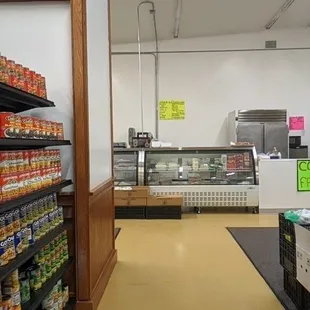Canned goods aisle with meat counter at the end
