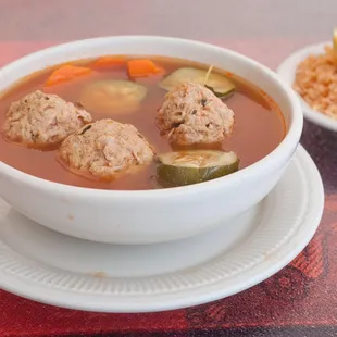 a bowl of soup and a plate of rice